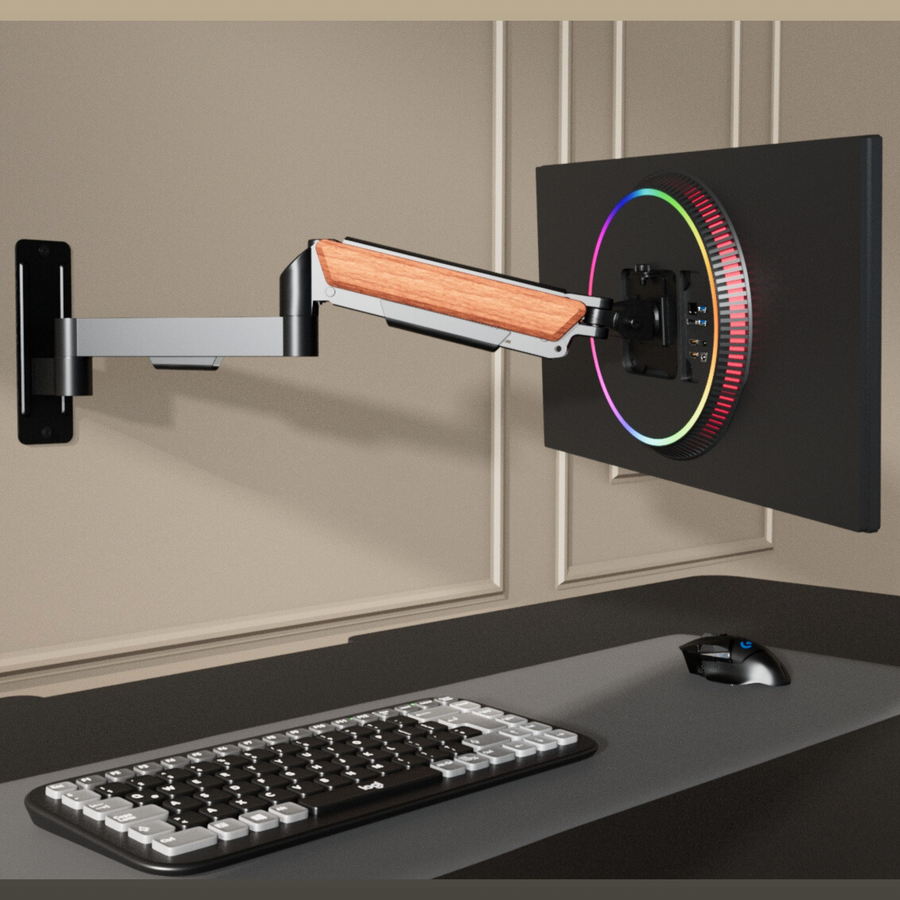 FlowArm Wall Mount in black — premium gas-spring monitor arm mounted on wall with RGB monitor and mechanical keyboard setup